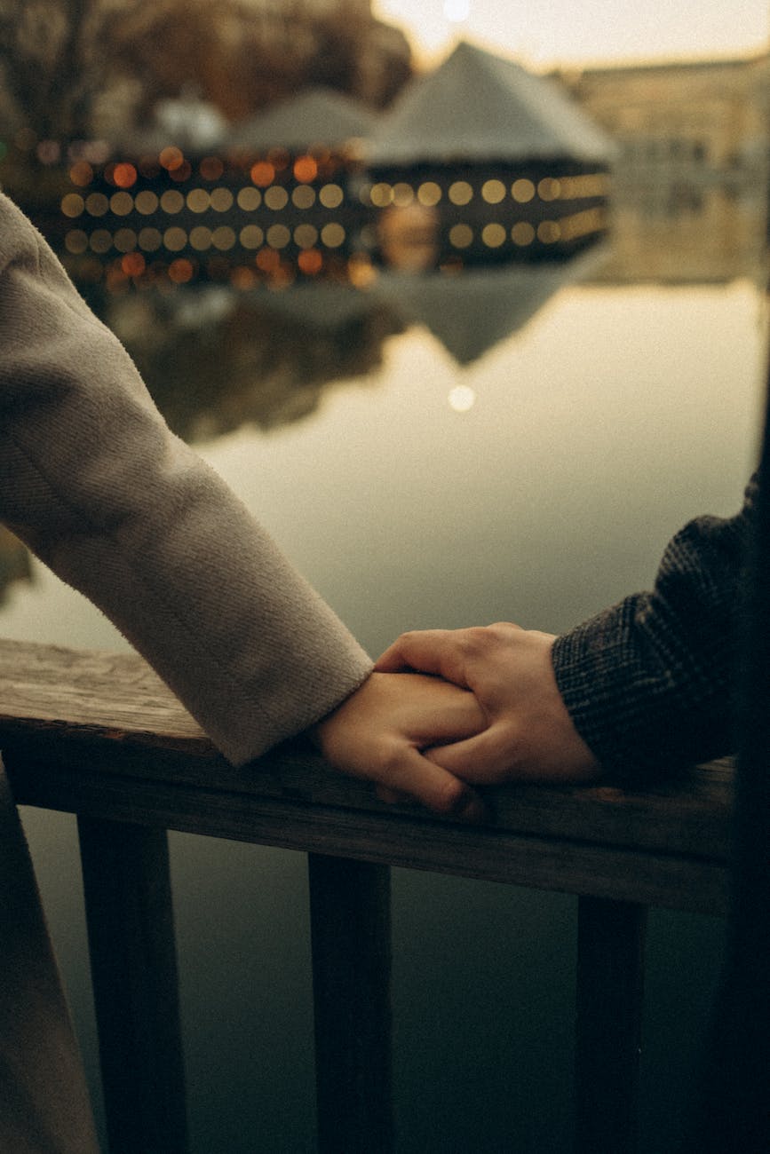 couple holding hands on the bridge